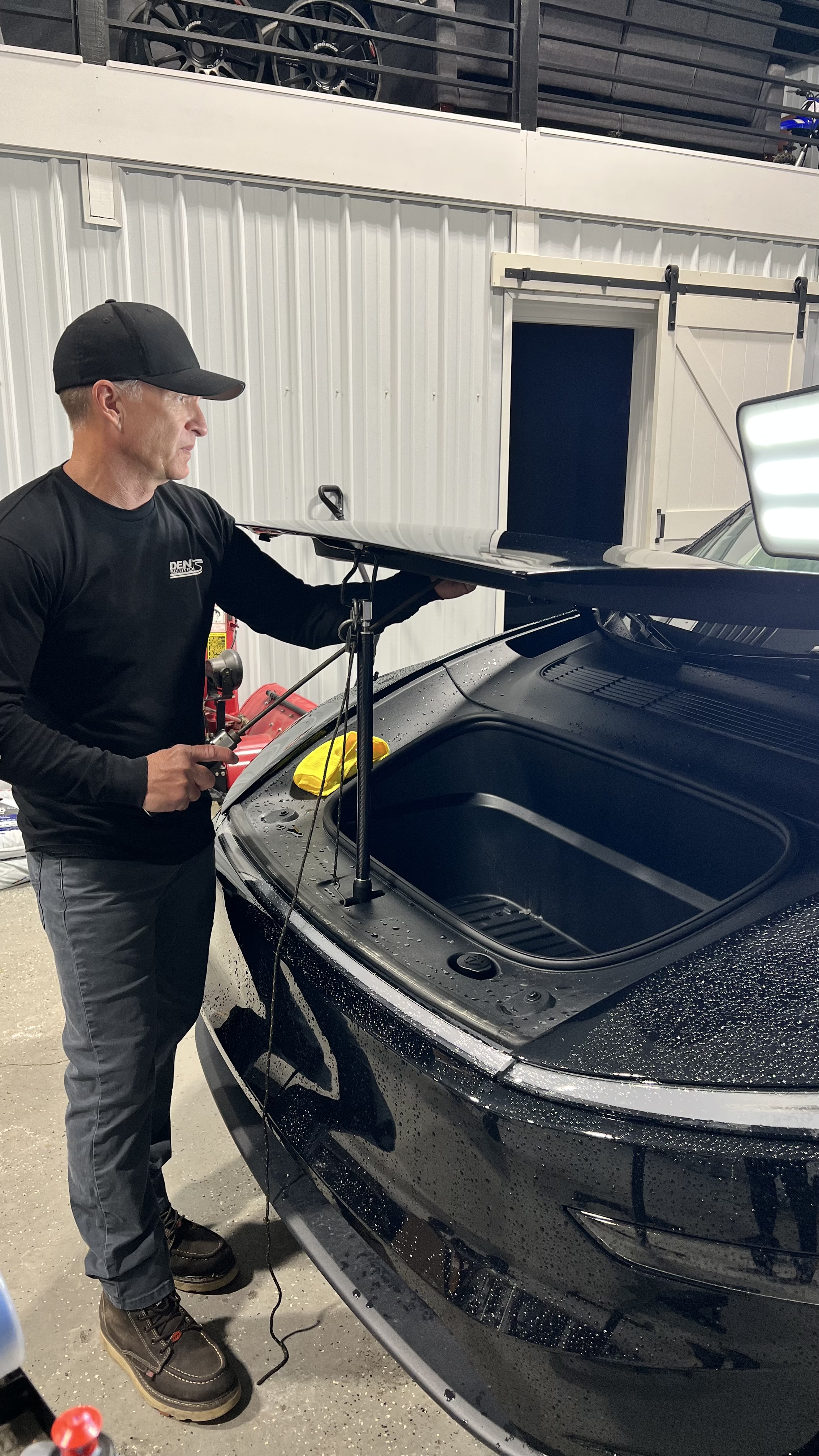 Mechanic leaning on Tesla hood causing dents